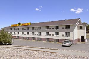 a hotel with a car parked in a parking lot at Super 8 by Wyndham Rapid City Rushmore Rd in Rapid City