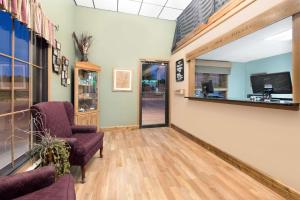 a waiting room with a chair and a window at Super 8 by Wyndham Chamberlain SD in Chamberlain