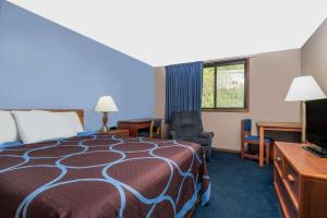 a hotel room with a bed and a tv at Super 8 by Wyndham Mankato in Mankato