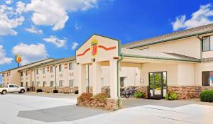 a hotel with a sign in front of a building at Super 8 by Wyndham St. James in Saint James