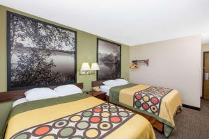 a hotel room with two beds in a room at Super 8 by Wyndham Fairmont in Fairmont