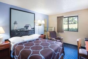 A bed or beds in a room at Super 8 by Wyndham Massena NY