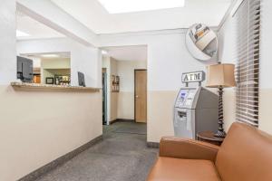 a waiting room with a couch and a bar at Super 8 by Wyndham Montgomery Maybrook in Montgomery