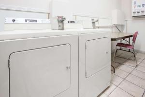 a washing machine in a room with a table at Grizzly Inn in Great Falls