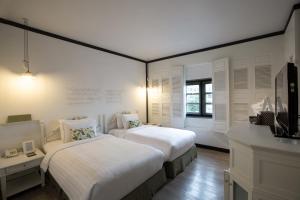 Ein Bett oder Betten in einem Zimmer der Unterkunft The Raweekanlaya Bangkok