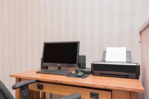 a desk with a computer and a printer on it at Super 8 by Wyndham Havre in Havre