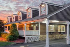 a house with a gambrel roof at Super 8 by Wyndham Christiansburg in Christiansburg