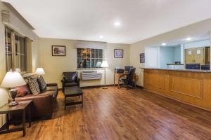 a living room with a couch and a kitchen at Super 8 by Wyndham Stroudsburg in East Stroudsburg