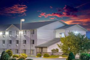 a large white building with a street light at Super 8 by Wyndham Altoona in Altoona