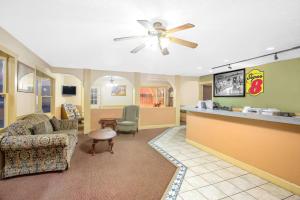 a lobby with a waiting room with a ceiling fan at Super 8 by Wyndham Christiansburg in Christiansburg