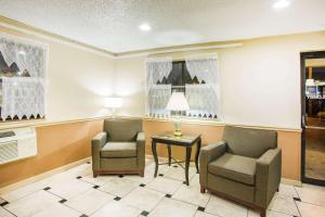 a waiting room with two chairs and a table at Super 8 by Wyndham Harrisonburg in Harrisonburg