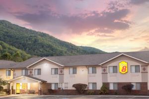 a inn with a mountain in the background at Super 8 by Wyndham Norton VA in Norton