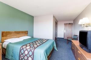 a hotel room with a bed and a flat screen tv at Super 8 by Wyndham Richmond Midlothian Turnpike in Midlothian
