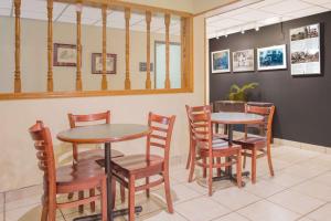 a dining room with two tables and chairs at Super 8 by Wyndham Appomattox VA in Appomattox