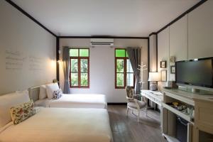 Ein Bett oder Betten in einem Zimmer der Unterkunft The Raweekanlaya Bangkok
