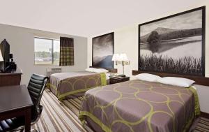 a hotel room with two beds and a desk at Super 8 by Wyndham Waynesboro in Waynesboro