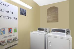 a laundry room with a washer and dryer at Super 8 by Wyndham Christiansburg/Blacksburg Area in Christiansburg
