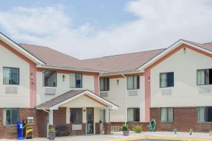 a building with a pool in front of it at Super 8 by Wyndham Appomattox VA in Appomattox