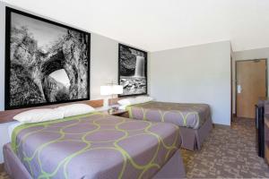 a hotel room with two beds and a tv at Super 8 by Wyndham Appomattox VA in Appomattox