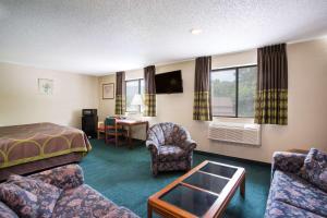 a hotel room with a bed and a desk at Super 8 by Wyndham Salem VA in Salem