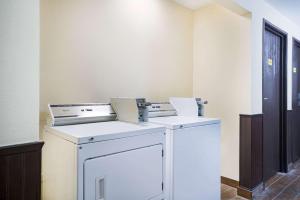a washer and dryer sitting in a room at Super 8 by Wyndham Marshall MN in Marshall