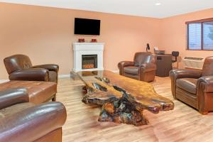a living room with a table and chairs and a fireplace at Super 8 by Wyndham Spokane/West in Airway Heights