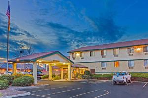 a hotel with a truck parked in a parking lot at Super 8 by Wyndham Union Gap Yakima Area in Union Gap