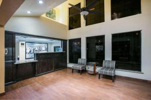 a large room with two chairs and a ceiling fan at Super 8 by Wyndham Oklahoma Airport Fairgrounds West in Oklahoma City