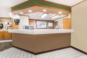 a lobby of a fast food restaurant with a counter at Super 8 by Wyndham Lexington in Lexington