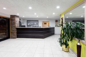 a waiting room with a counter in a restaurant at Super 8 by Wyndham Sapulpa/Tulsa Area in Glenpool +26 photos