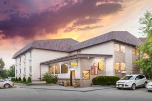 a fast food restaurant with cars parked in front of it at Super 8 by Wyndham Buffalo in Buffalo