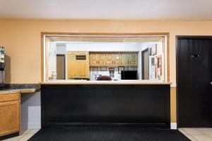 a large kitchen with a large black counter top at Super 8 by Wyndham Dumfries/Quantico in Dumfries