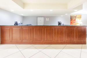 a bar in a room with wooden cabinets at Super 8 by Wyndham West Monroe in West Monroe