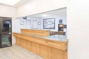 a large kitchen with a counter in a room at Super 8 by Wyndham Terre Haute in Terre Haute