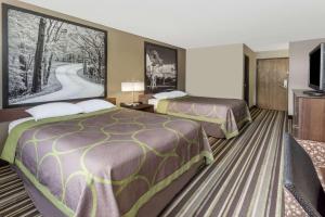 A bed or beds in a room at Super 8 by Wyndham Plymouth