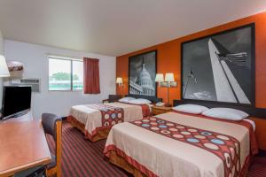 a hotel room with two beds and a desk at Super 8 by Wyndham Dumfries/Quantico in Dumfries