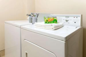 a washing machine with towels on top of it at Super 8 by Wyndham Springfield East in Springfield +5 photos