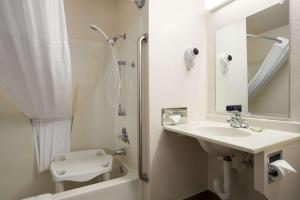 a bathroom with a sink and a shower and a toilet at Super 8 by Wyndham Las Vegas in Las Vegas +22 photos