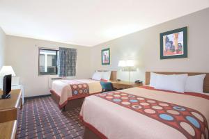 A bed or beds in a room at Super 8 by Wyndham Douglas