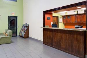 a lobby with a bar in a hospital at Super 8 by Wyndham Clearwater/St. Petersburg Airport in Clearwater