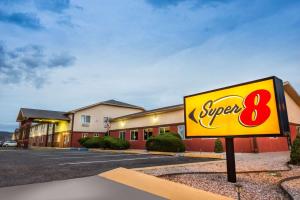 a sign for a super restaurant in a parking lot at Super 8 by Wyndham Grants in Grants