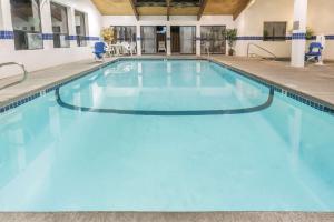 een groot zwembad met blauw water in een gebouw bij Super 8 by Wyndham Bend in Bend