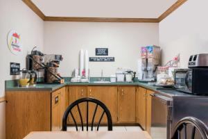 a kitchen with a counter top and a dishwasher at Super 8 by Wyndham Sheldon in Sheldon