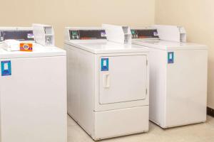 three white refrigerators are lined up in a room at Days Inn by Wyndham Portage in Portage