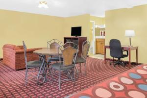 a room with a table and chairs and a couch at Super 8 by Wyndham Kerrville TX in Kerrville