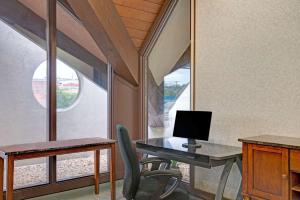 an office with a desk with a computer and a chair at Days Inn by Wyndham Washington in Washington +3 photos