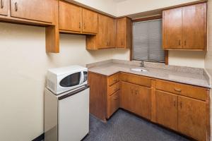 a small kitchen with a microwave and a refrigerator at Days Inn by Wyndham Walterboro in Walterboro