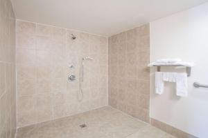 a bathroom with a shower with a glass door at Super 8 by Wyndham Augusta in Augusta