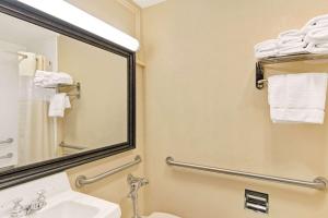 a bathroom with a sink and a mirror and towels at Days Inn by Wyndham Washington in Washington +3 photos