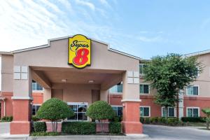 a sign for aasy restaurant in front of a building at Super 8 by Wyndham Fort Worth North in Fort Worth